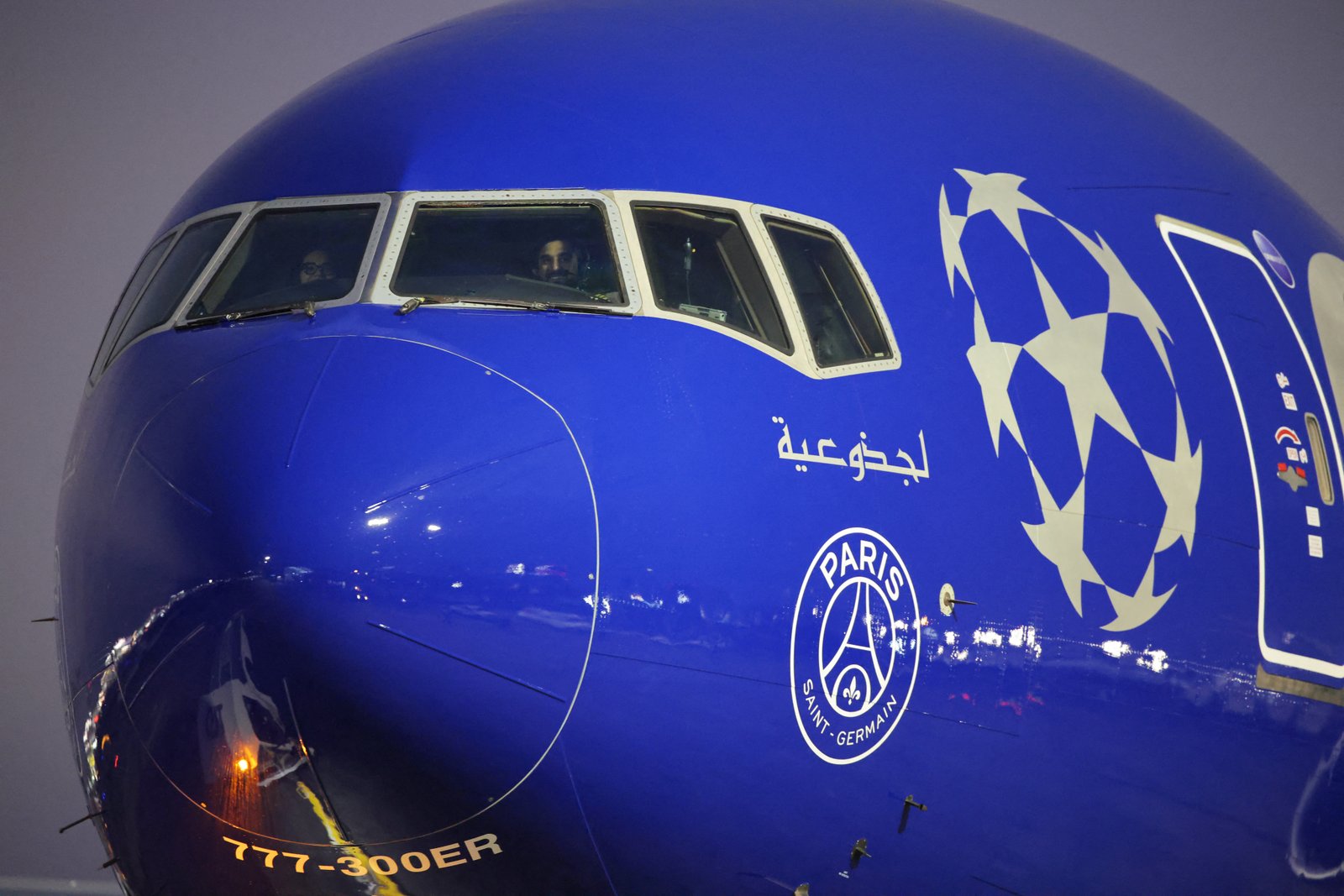 paris Saint-Germain team arriving on Qatar Airways flight featuring club logos