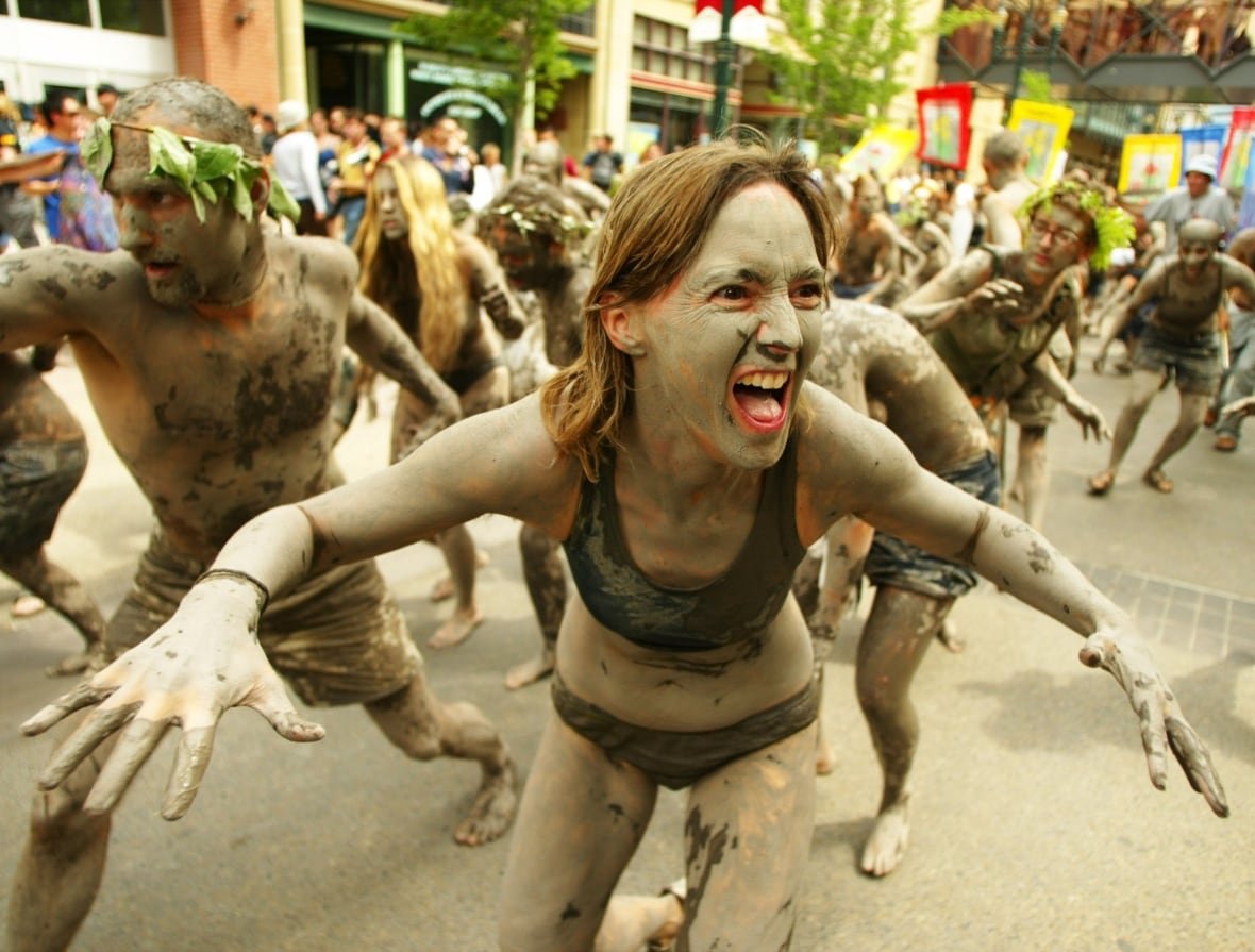 Peaceful anti-globalization protesters covered in mud downtown Calgary.