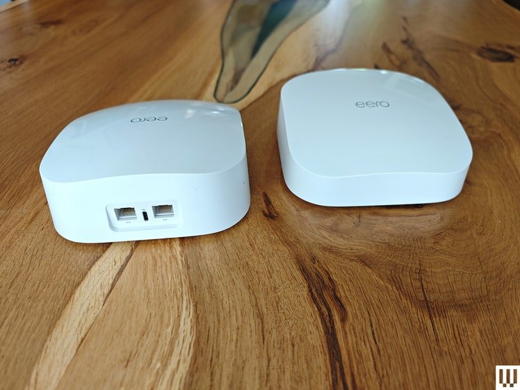 Eero 6 mesh System, two white rectangular devices on wooden table