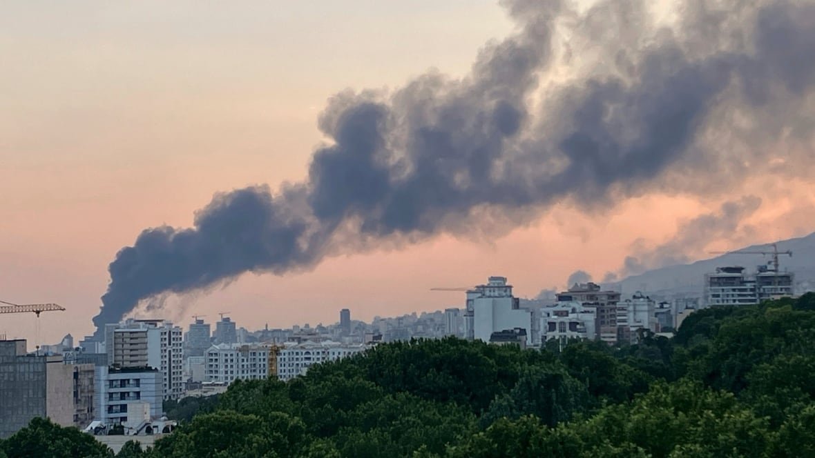 Smoke rising over city skyline after airstrike