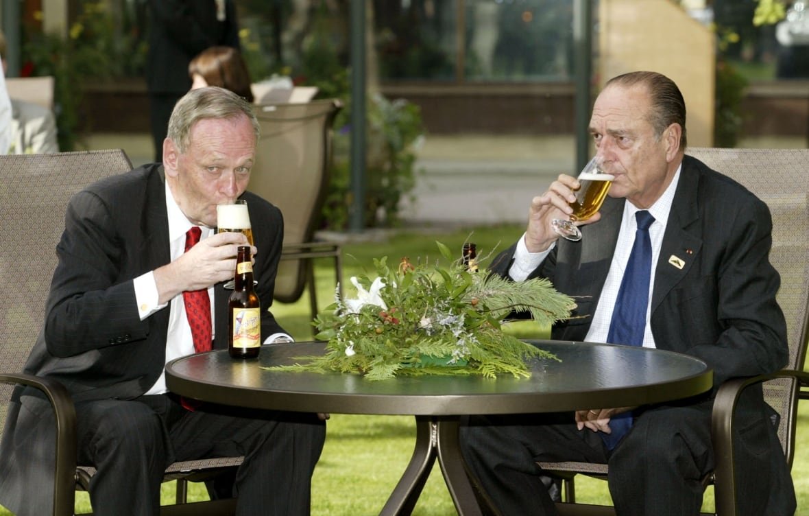 Jean Chretien sharing informal moment outdoors with Jacques Chirac.