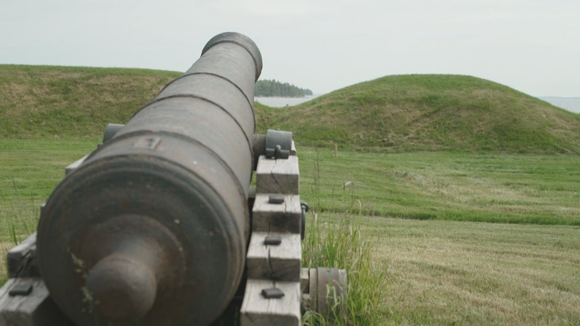 Historic cannon overlooking coastal landscape
