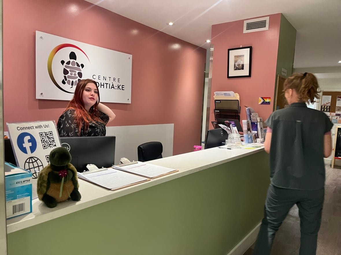 Two staff members smiling inside a radiant clinic reception area