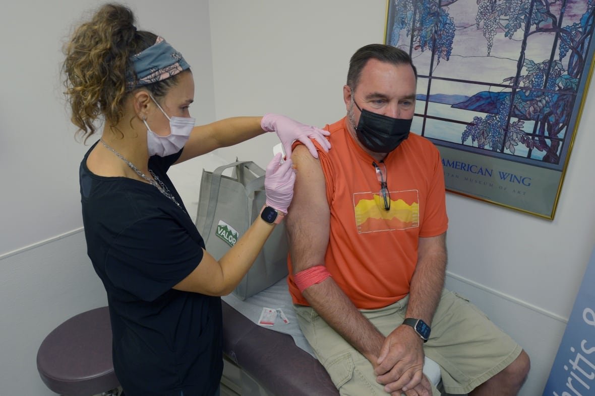 Healthcare professional administering injection.