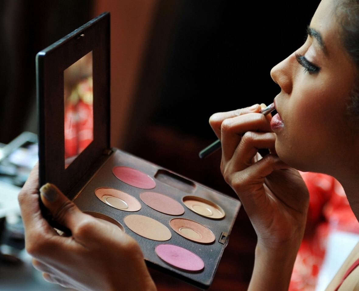 Woman applying makeup carefully