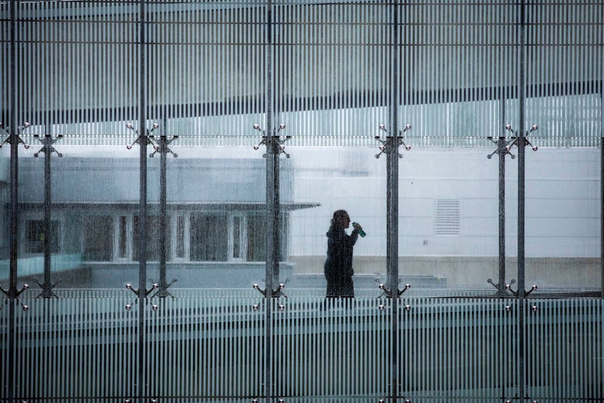 Student walking through university hallway silhouette