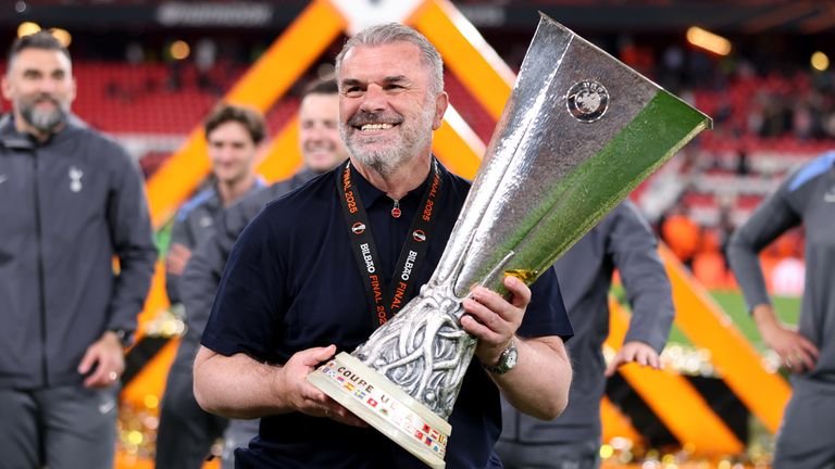 ange Postecoglou holding Europa League trophy