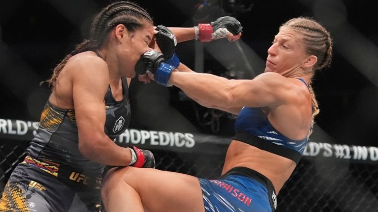 Kayla Harrison punches Julianna Peña during second round women's bantamweight title bout