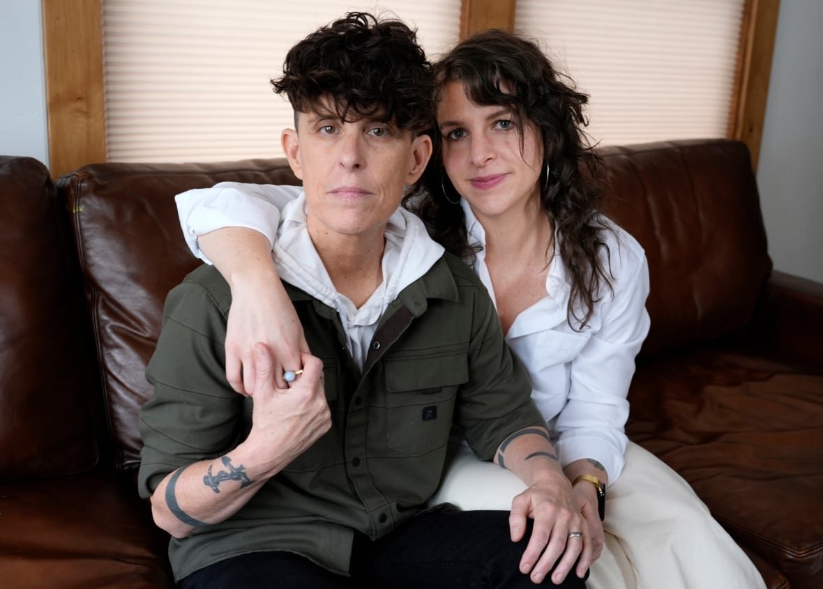 Andrea Gibson smiling beside spouse