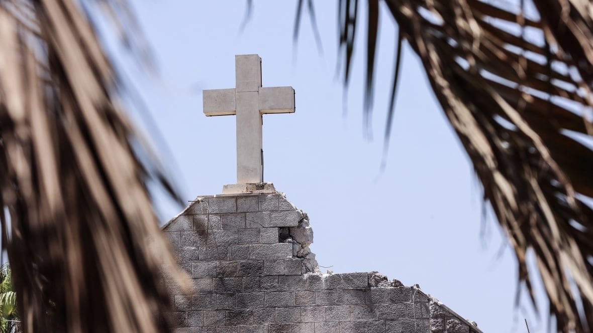 Damaged cross atop Holy Family Church roof after airstrike