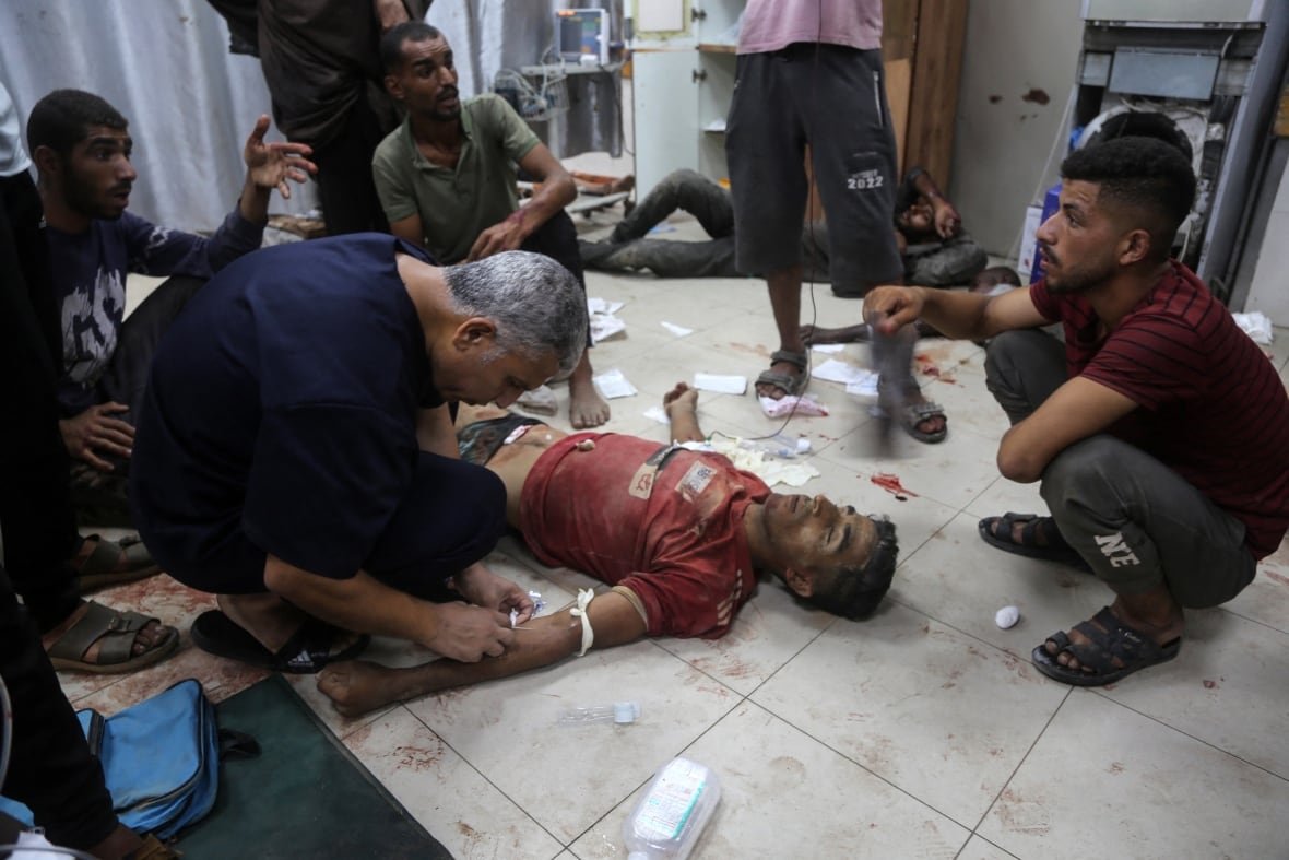 Medical personnel treating injured Palestinians after shootings near gaza aid point