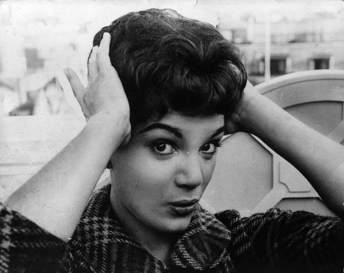 Black-and-white portrait showing young Connie adjusting hair