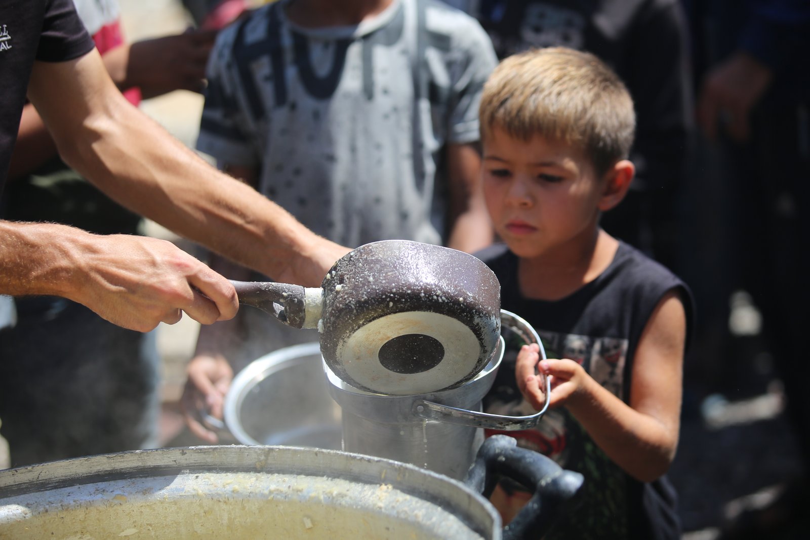 Volunteers distributing food aid in Nuseirat refugee camp