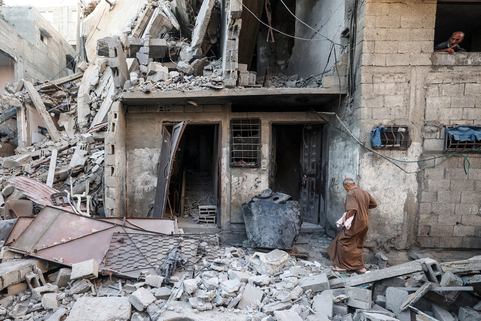 Palestinians assess damage to homes in Al-Bureij camp, central Gaza Strip