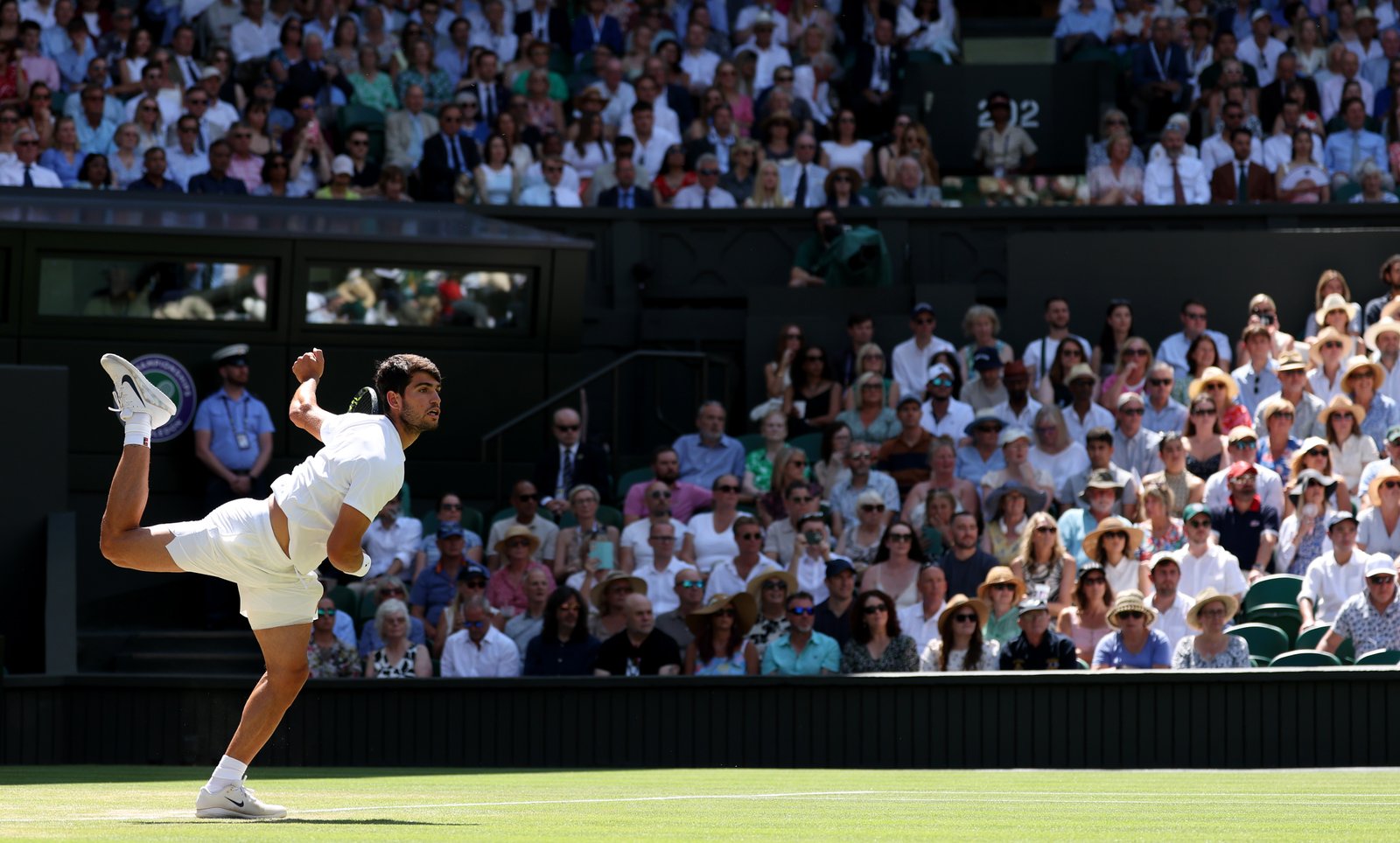 Carlos Alcaraz serving against Taylor Fritz during Wimbledon semifinal