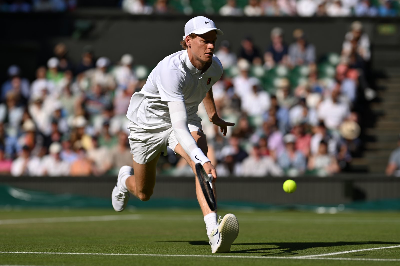 Jannik Sinner competing against Novak Djokovic during Wimbledon semifinal