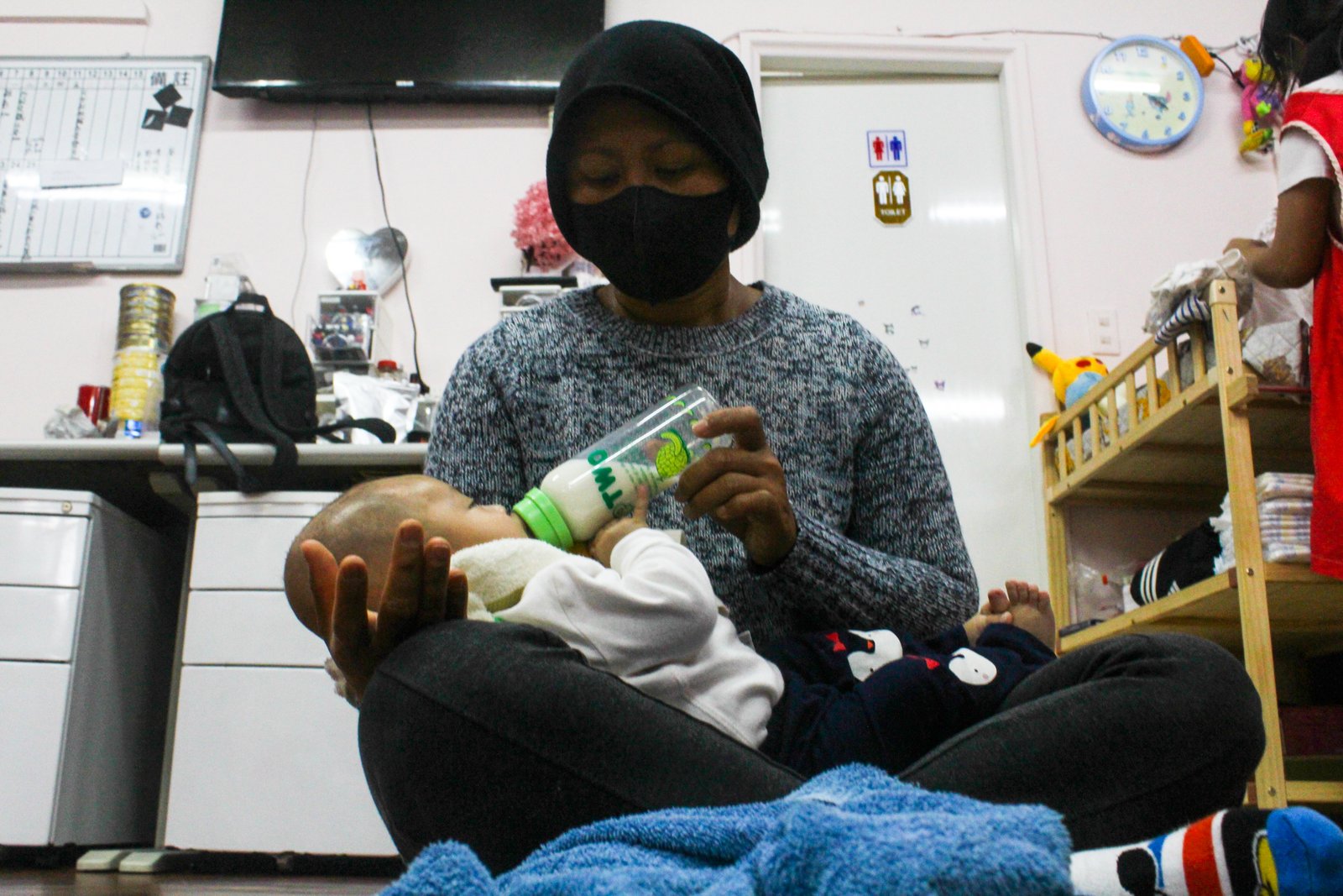 Migrant caregiver attending a child