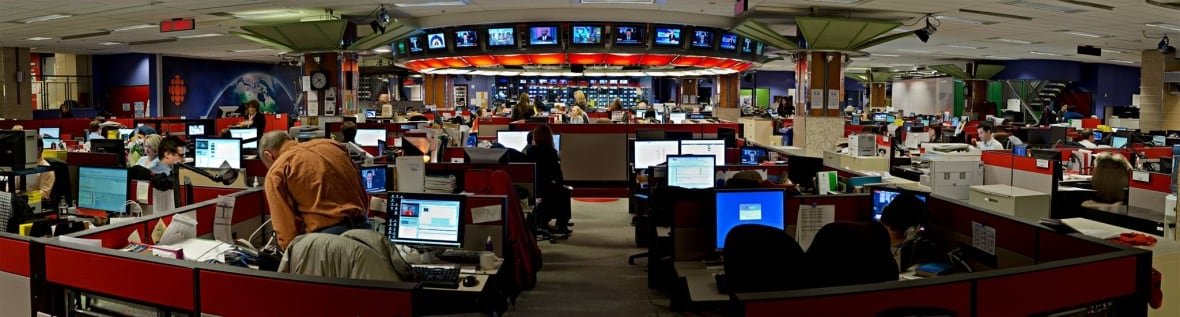 CBC newsroom with journalists at workstations