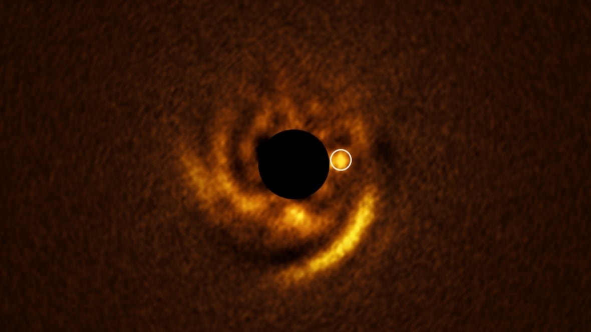 Protoplanetary disk with shining spot indicating candidate forming planet