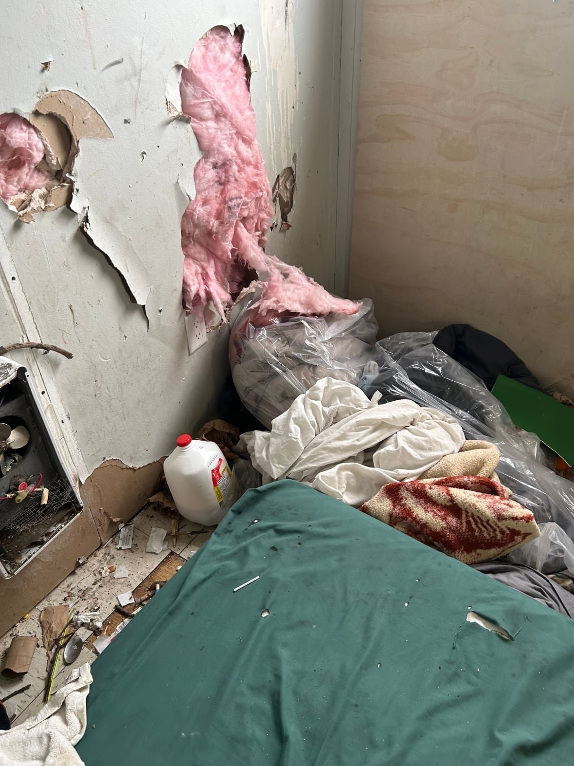 Interior damage showing exposed insulation in a supportive housing unit