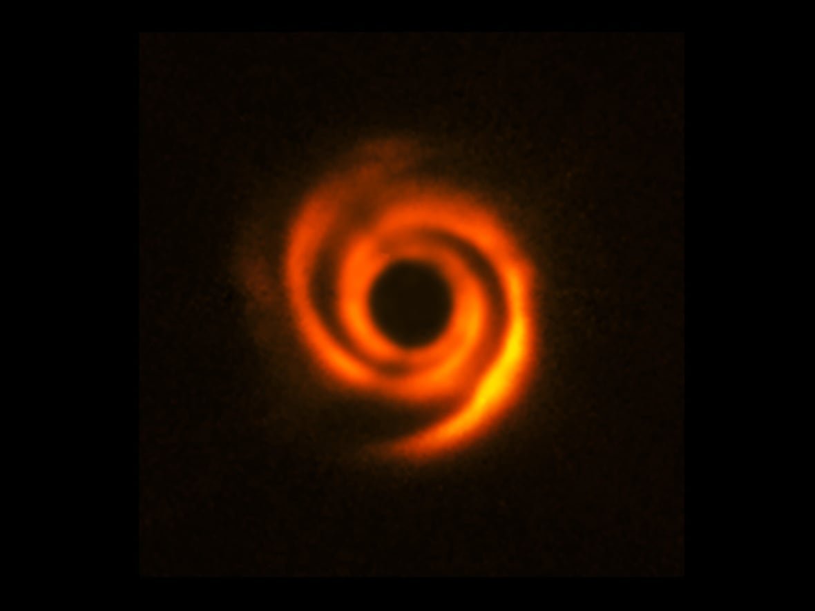 Earlier image showing vivid spiral arms around young star