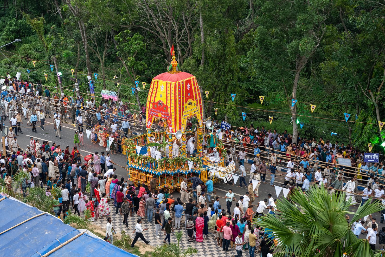 Chariots pulled during Rath Yatra procession observed behind barricades