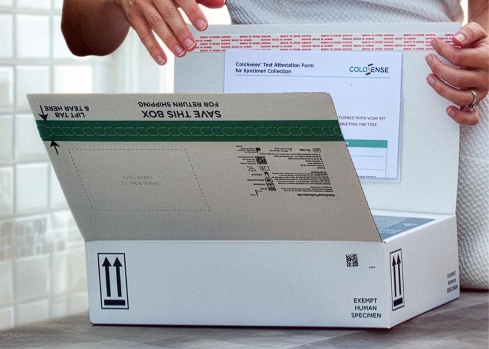 Patient opening ColoSense kit at home