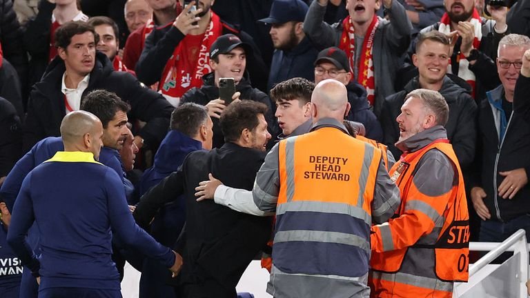 Diego Simeone restrained by stewards during Champions League match