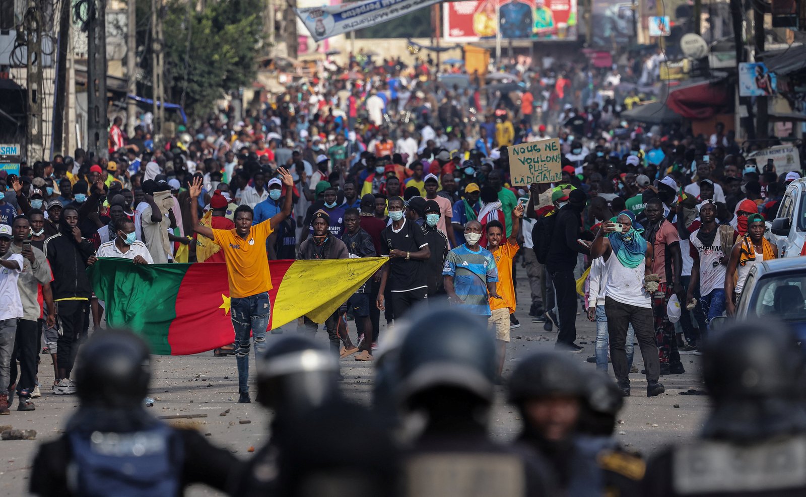 Crowd protesting with Cameroonian flags