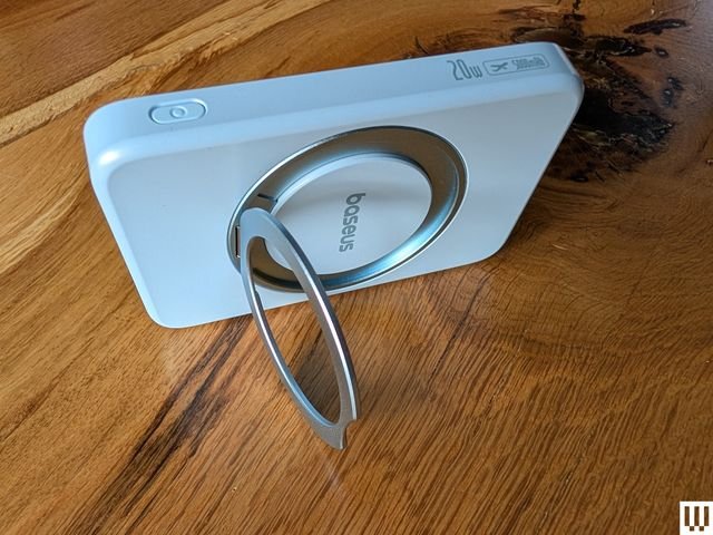 Baseus PicoGo Qi2 MagSafe ⁣Power Bank,‍ a white rectangular device for ‍charging other devices with a retractable ‍circular kickstand propping it ​up