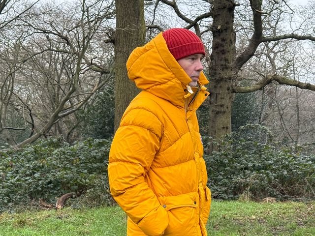 Person wearing orange Fjallraven Expedition Down Lite Jacket