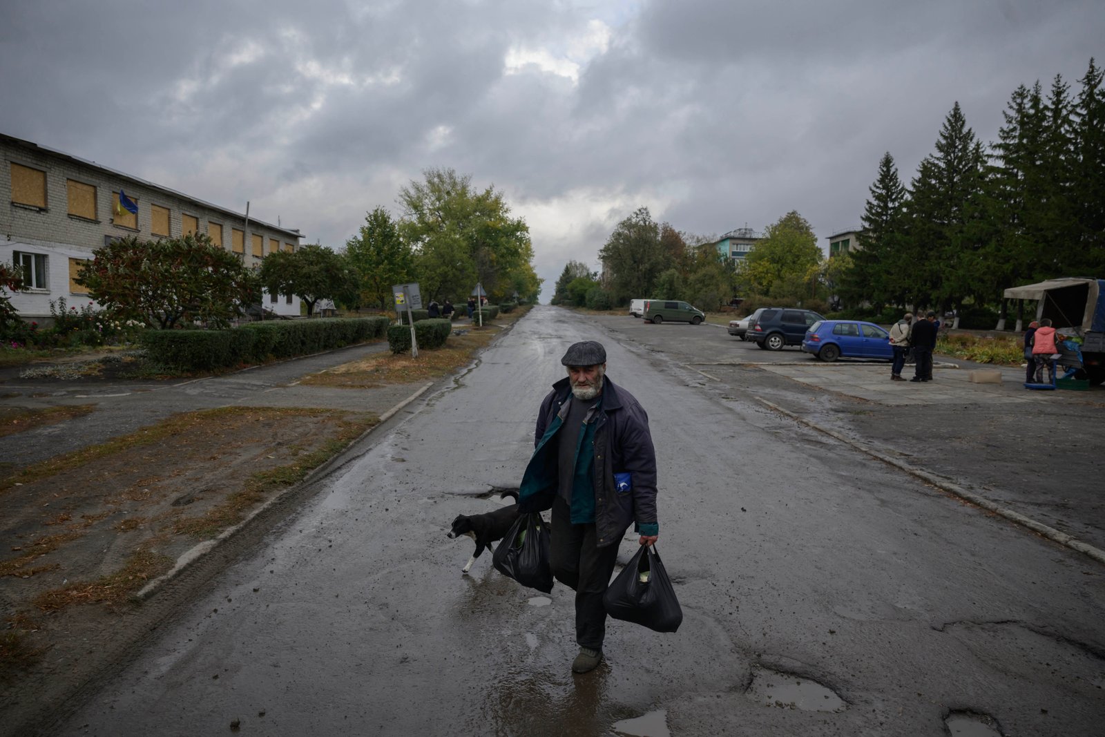 A man carrying bags filled with vegetables purchased from a farmer in Borivske village, Kharkiv region, eastern Ukraine during the ongoing Russian invasion.