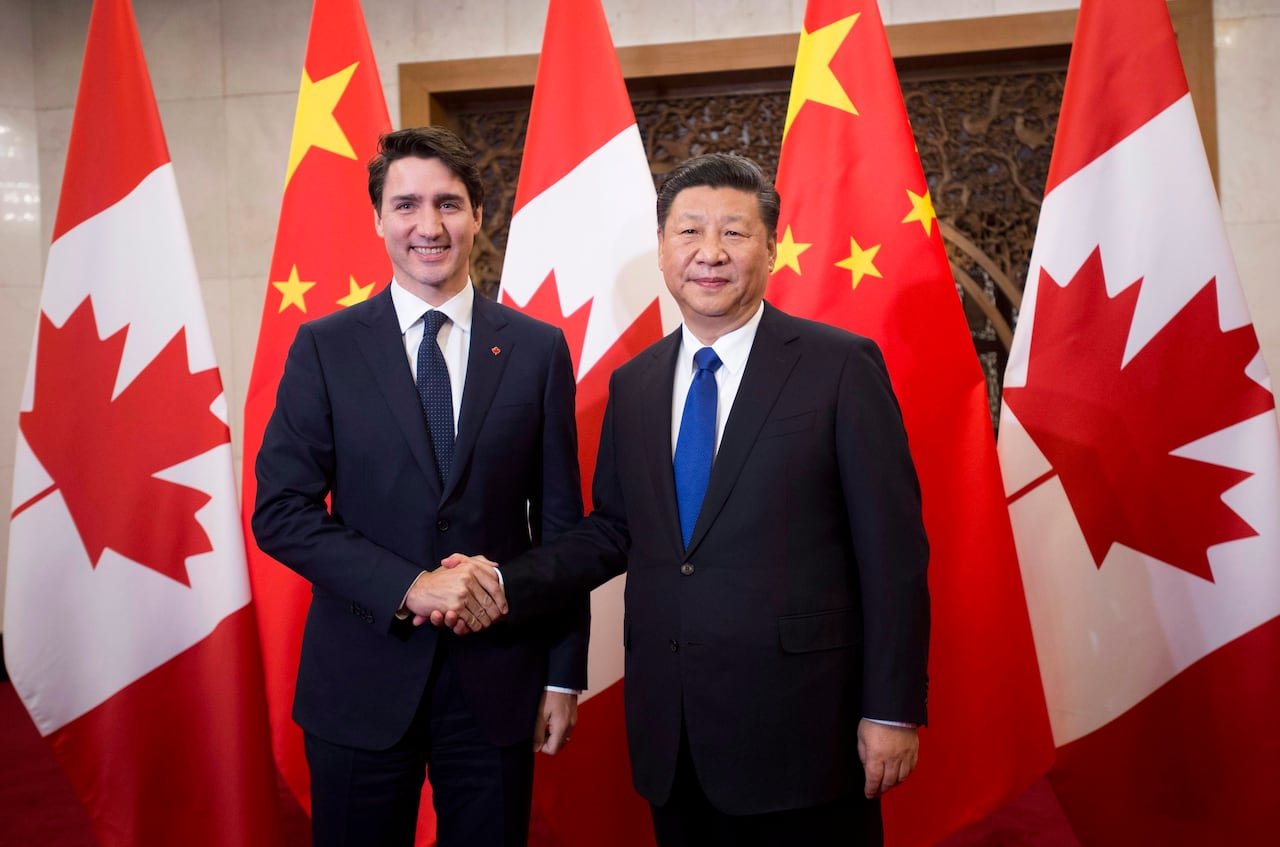 Canadian Prime Minister shaking hands with Chinese President