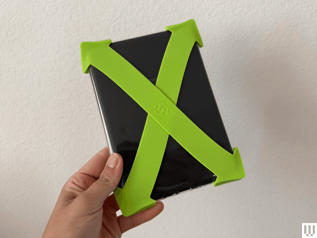 E-reader with neon hand strap attached