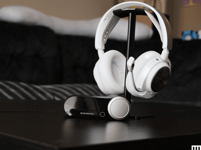 White SteelSeries Arctis Nova pro Wireless Headset resting on stand with cushioned ear cups