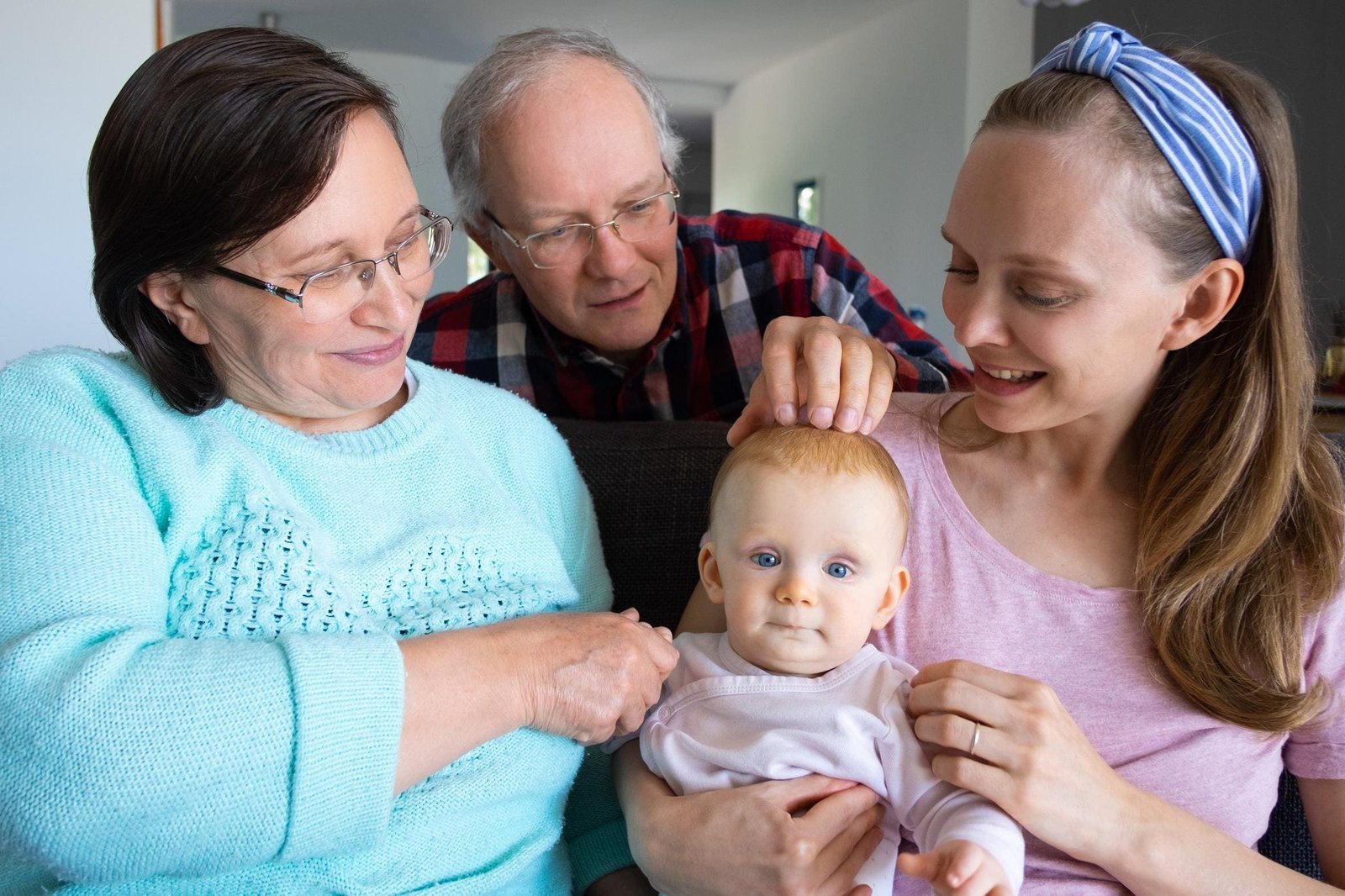 happy grandparents spending quality time with their daughter and granddaughter