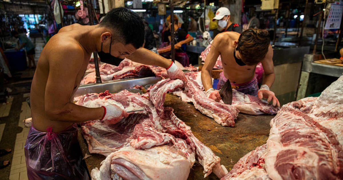 Butchers preparing pork at Bangkok market