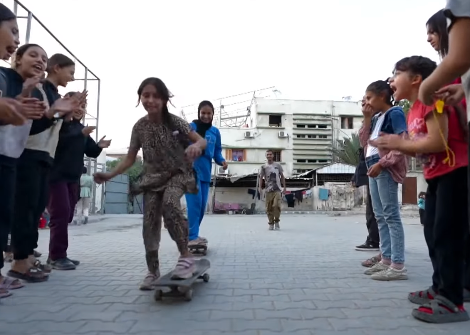 Children skateboarding among ruins in Gaza