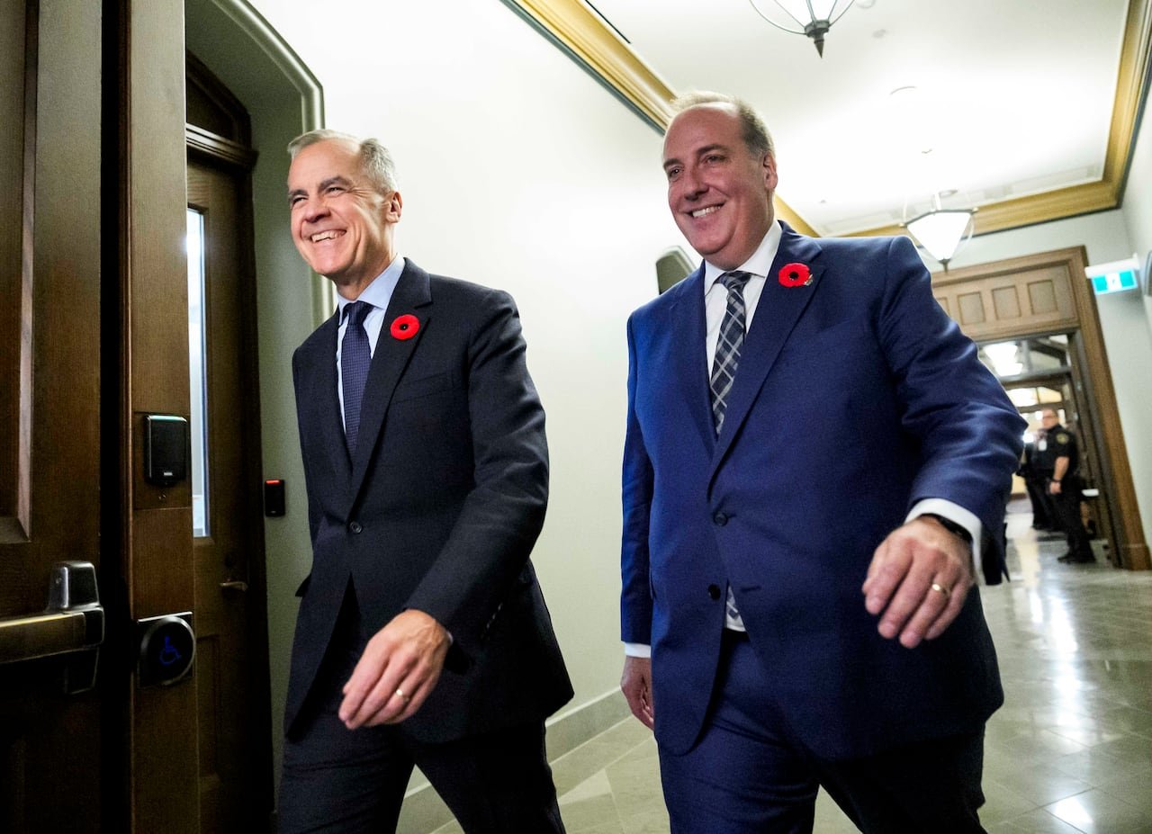 Prime Minister Mark Carney walking alongside MP Chris d'Entremont