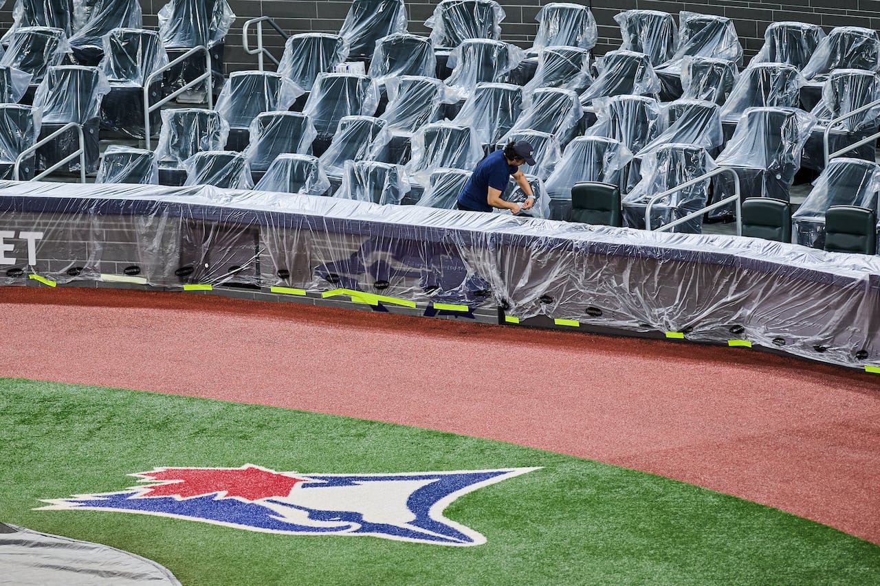 Empty seats wrapped in plastic at baseball stadium preparing offseason maintenance