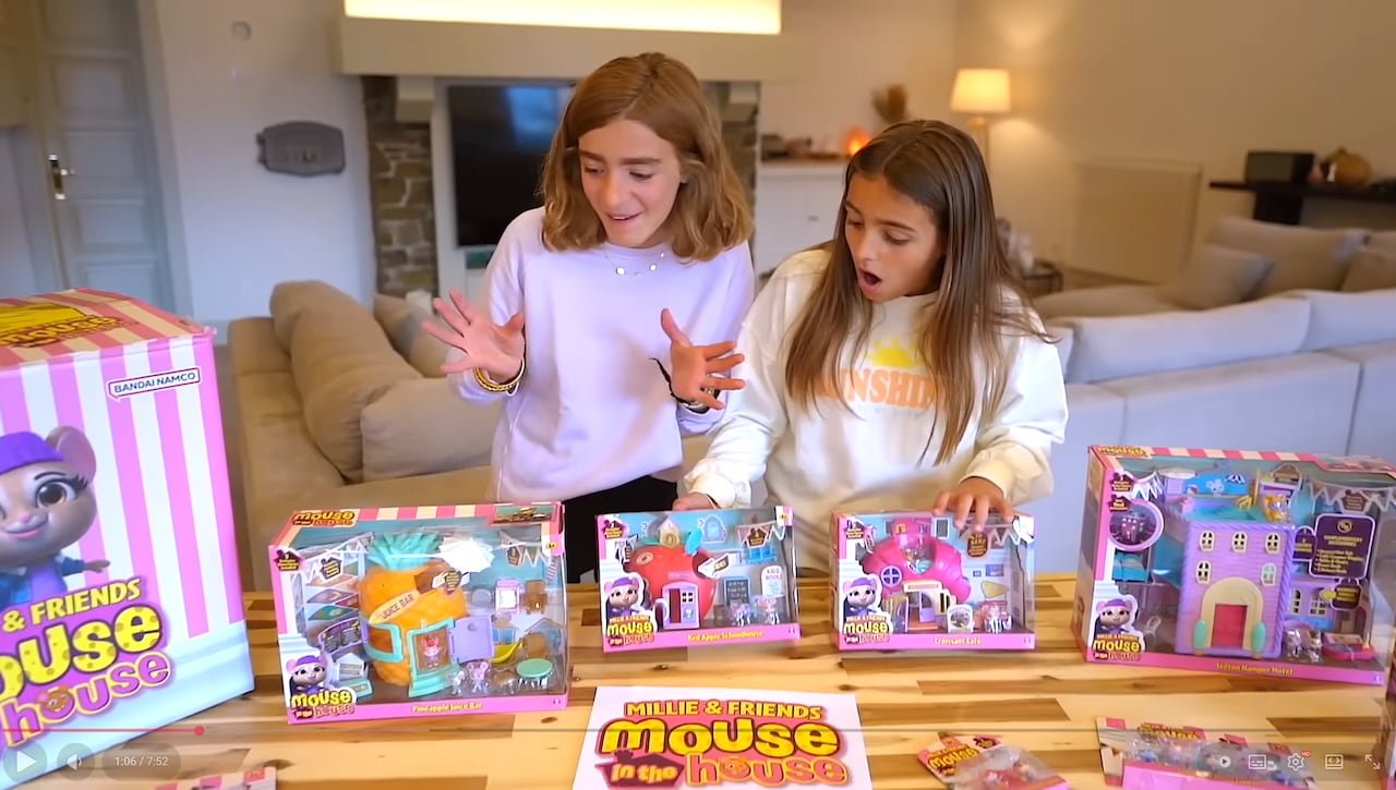 Two young siblings unboxing toys on camera
