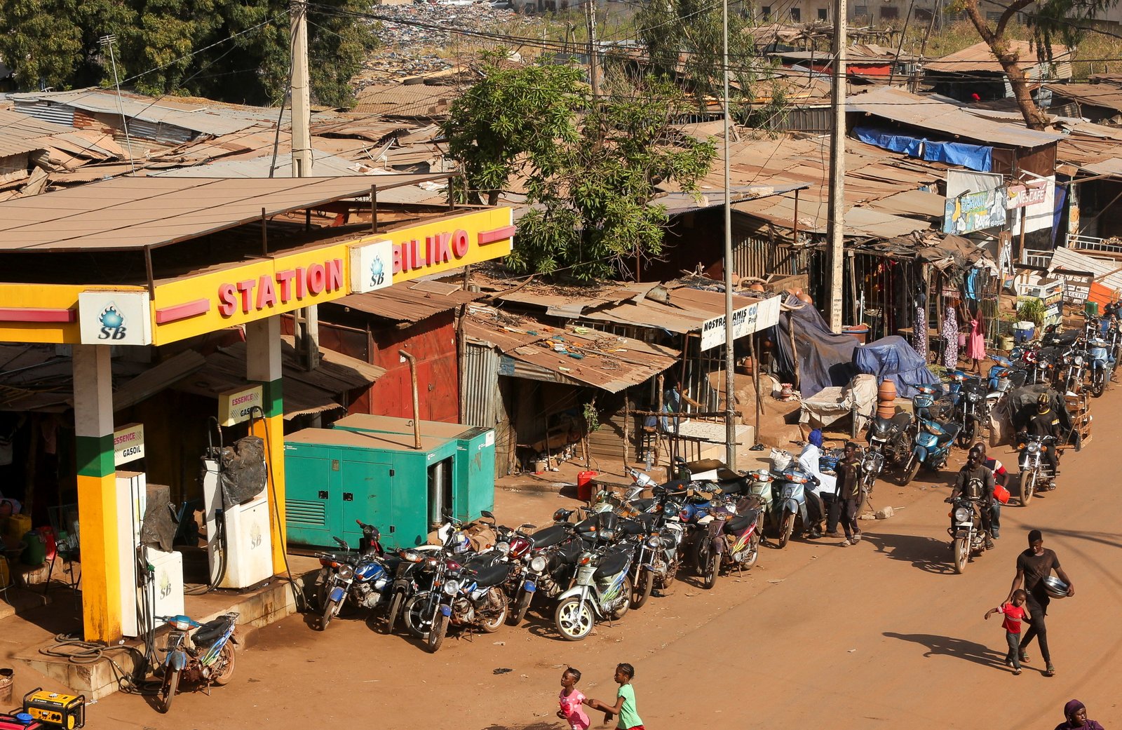 Motorcycles lined up near closed petrol station during fuel shortages in Bamako
