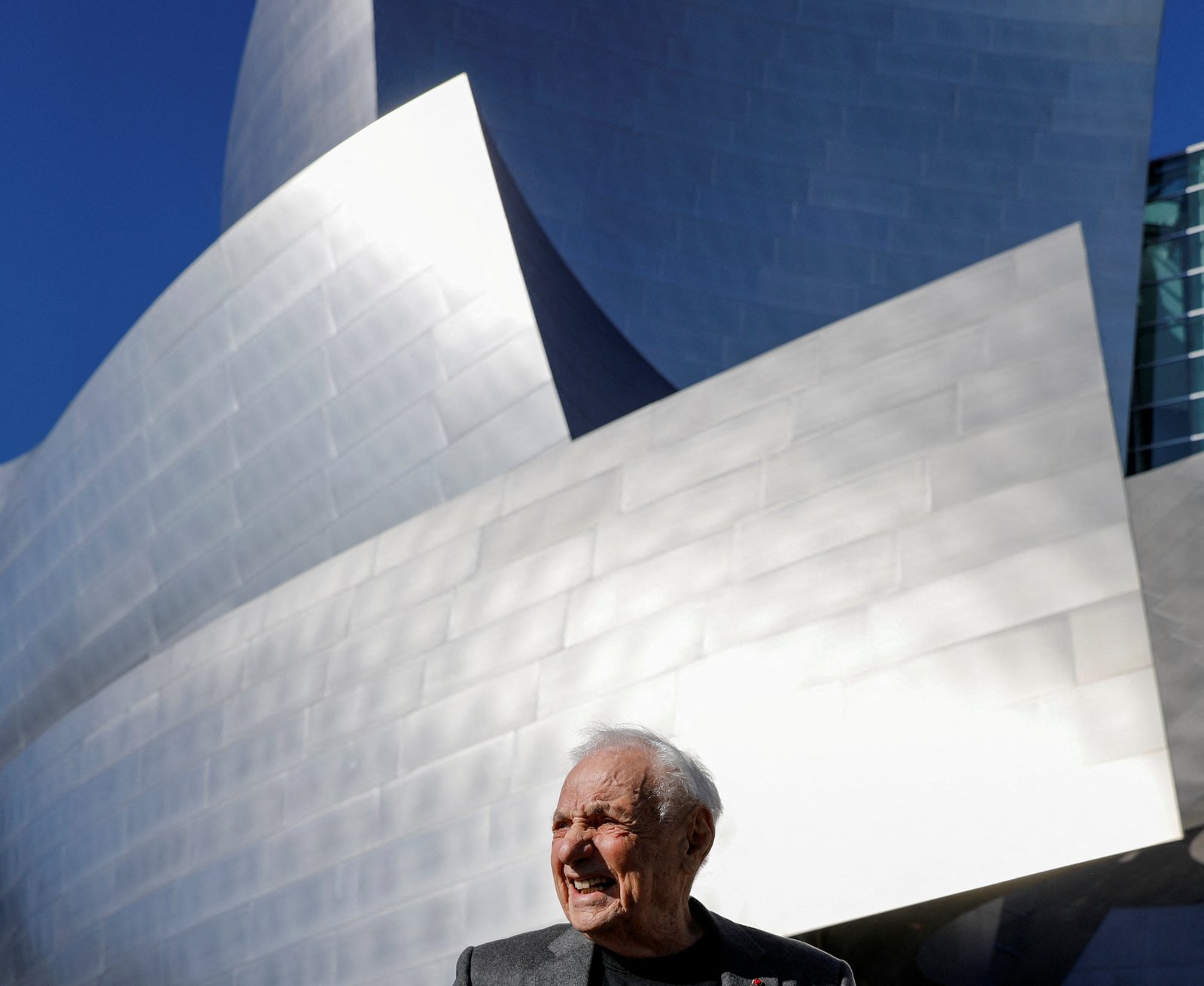 Frank Gehry standing before Walt Disney concert Hall