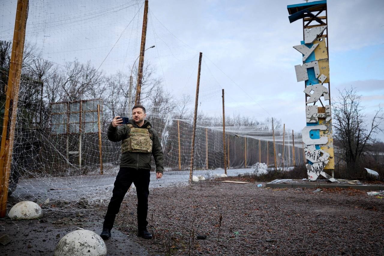 Ukrainian President Volodymyr Zelenskyy records a video in front of a Kupiansk sign amid ongoing conflict in Kharkiv region