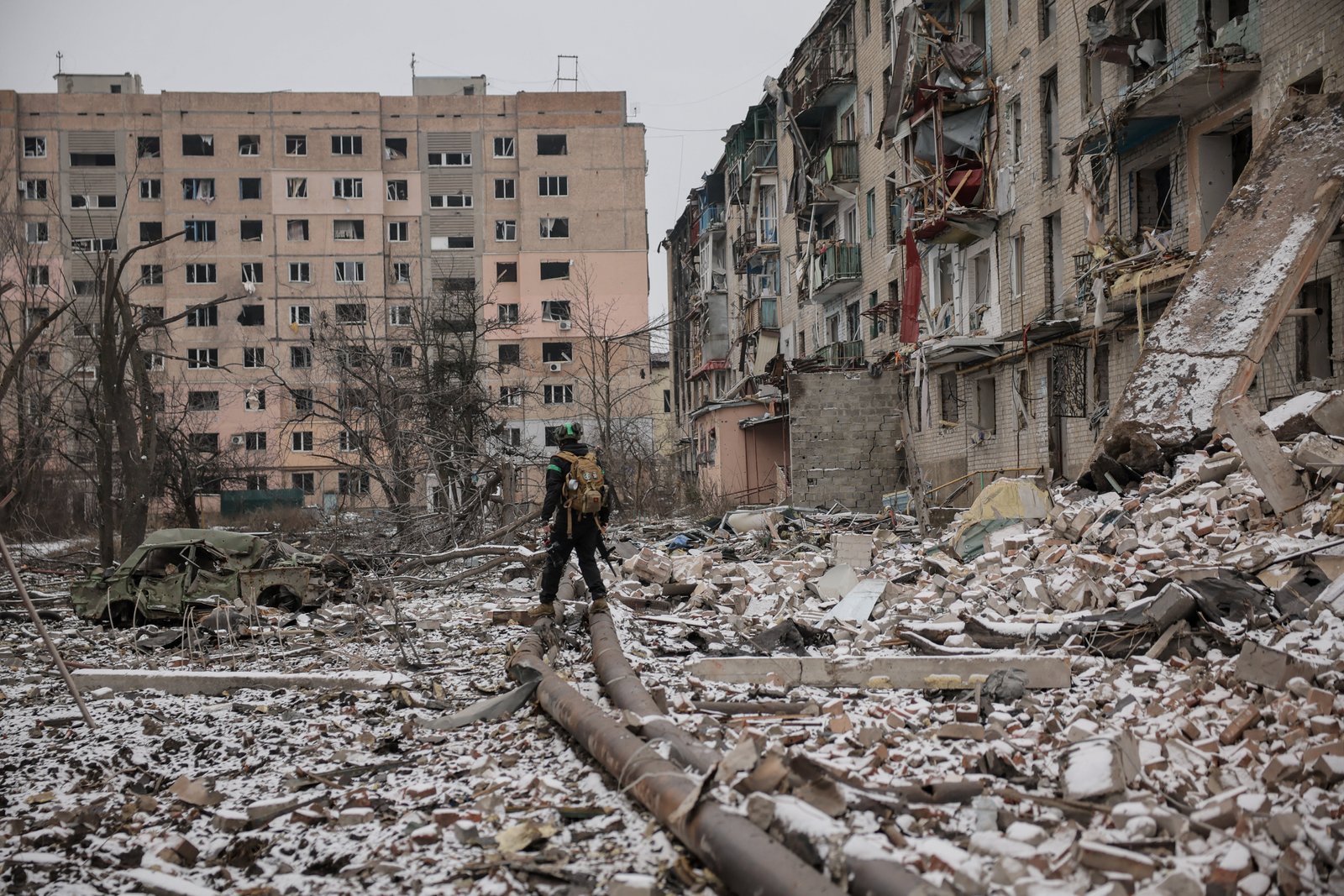 Ukrainian soldier near buildings damaged by Russian strike in Kostiantynivka, Donetsk region