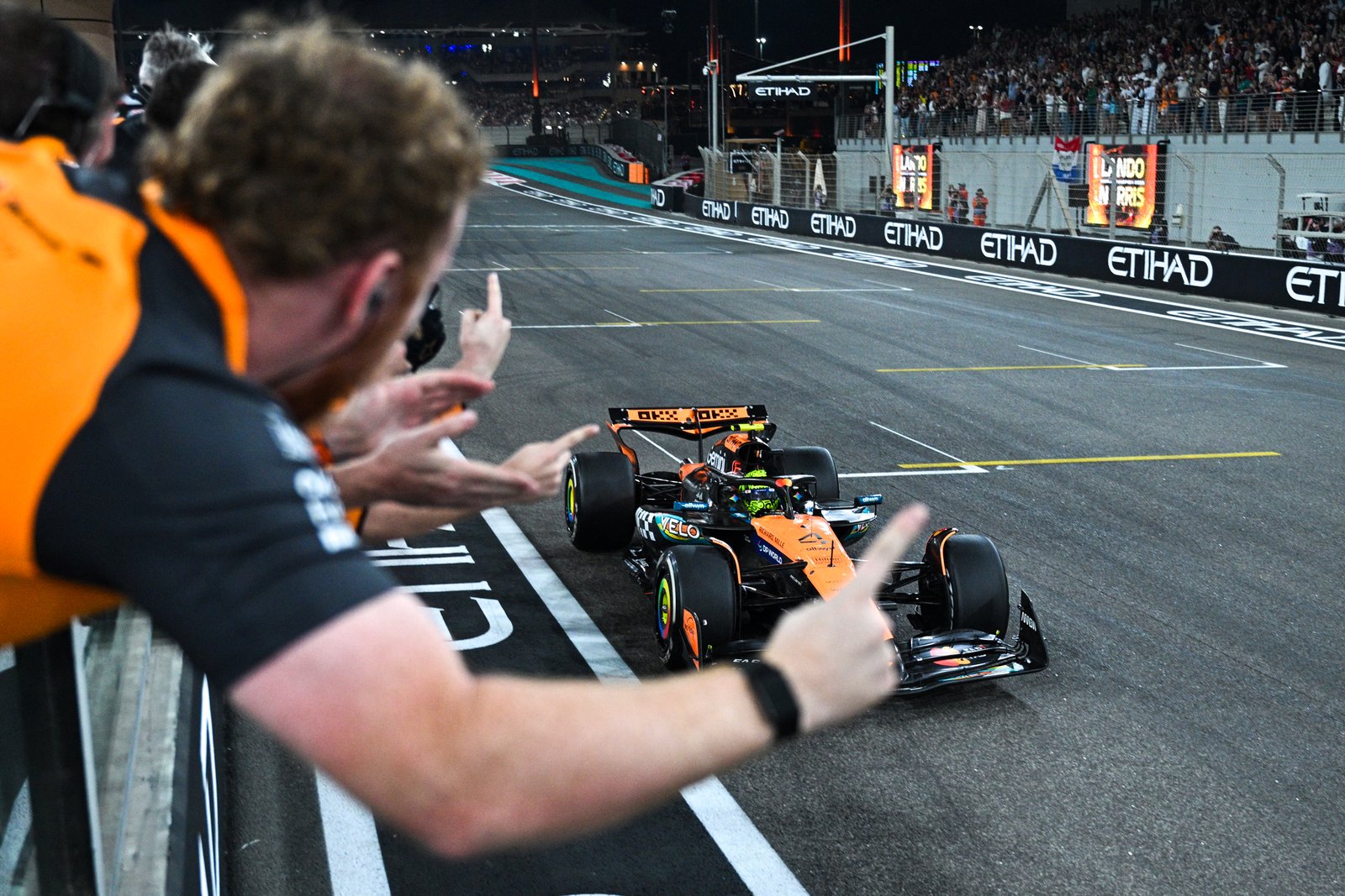 Lando Norris crossing finish line