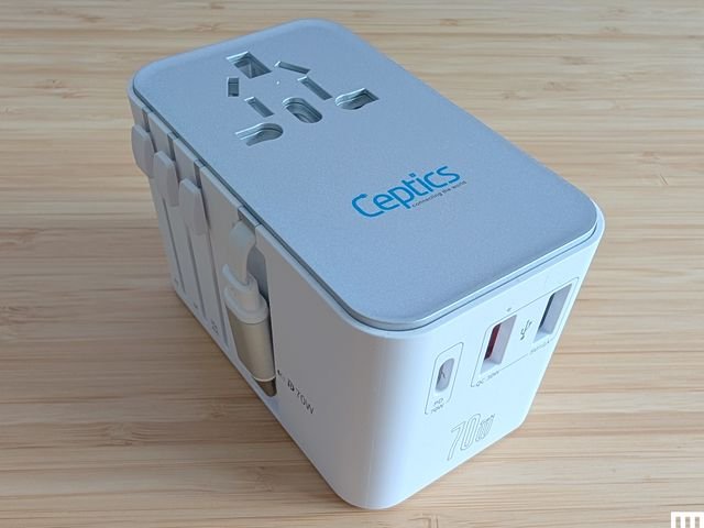 Ceptics GaN 70W Universal Travel Adapter, a white and grey electronic block with outlets and small cord tucked into a slot