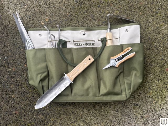 Green tote bag filled with gardening tools