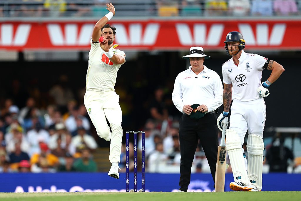 Mitchell Starc bowling during second Ashes Test as Ben Stokes watches