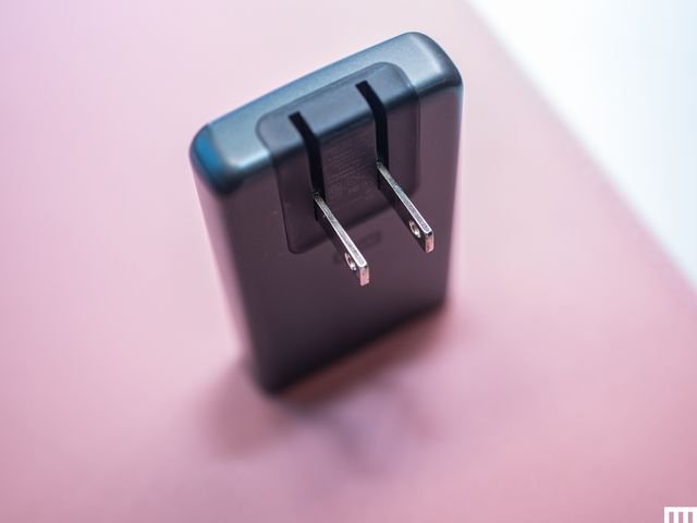 Slender black charger with two metal prongs protruding